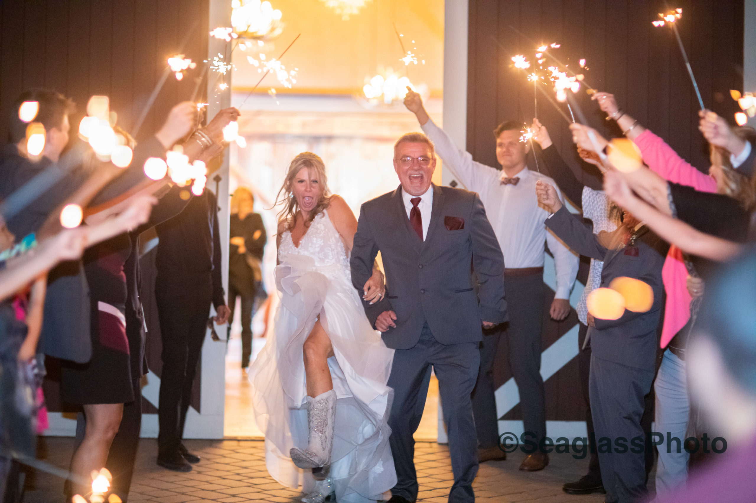 bride and groom dancing as they exit the reception at Grant Barn Station while guests held up sparklers