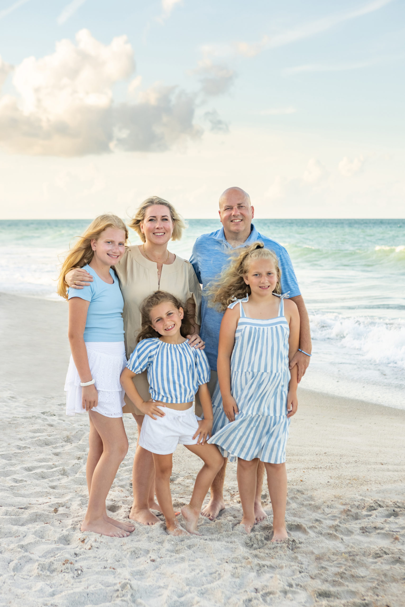 Mom and dad with three daughters on the beach at Disney Vero Beach 