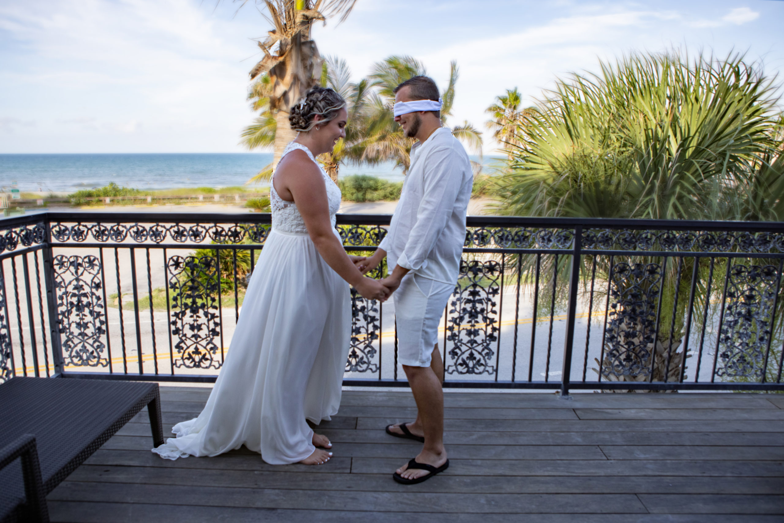 bride and groom praying on a balcony overlooking the ocean in Melbourne Beach 
