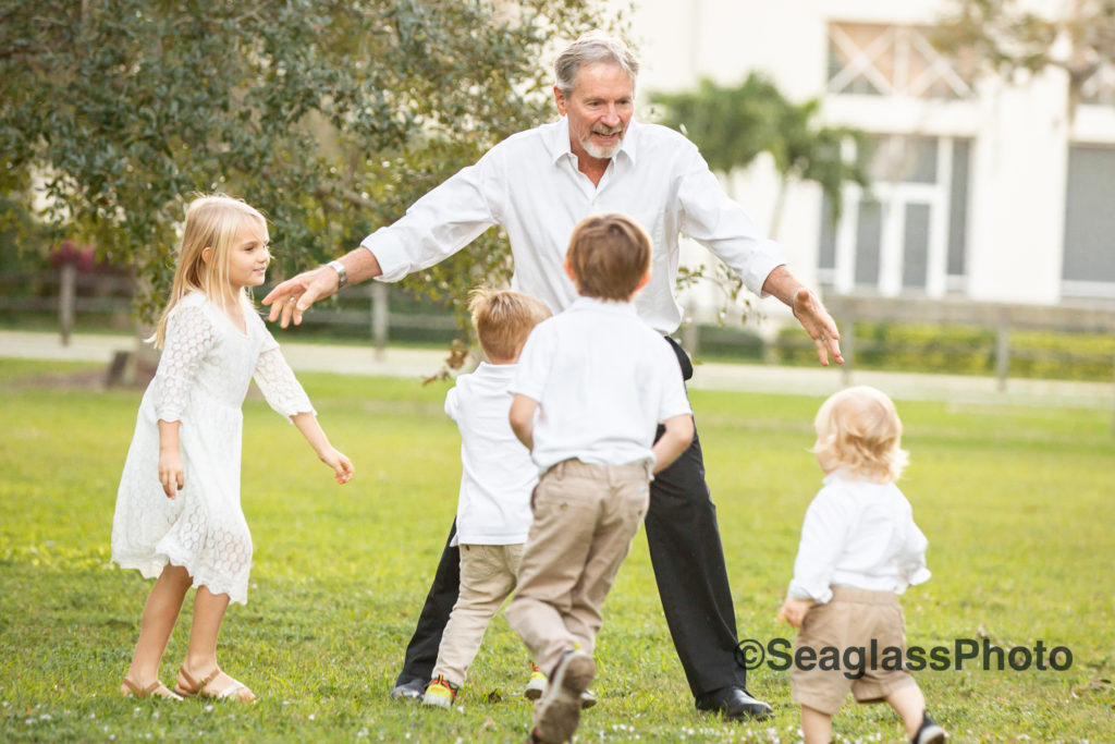 grandfather chasing grandkids around a park in Vero Beach Florida 