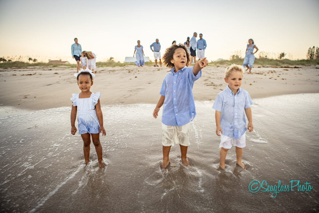 kids standing on the shoreline watching the waves crashing Vero Beach Florida 