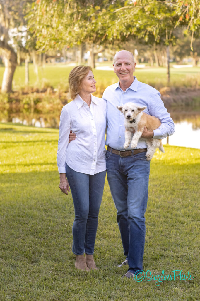 couple holding a dog at John's Island Golf Club in Vero Beach Florida 