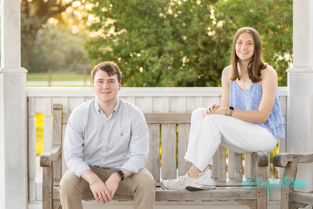 sibling photo of teens sitting on a bench at Riverside Park in Vero Beach Florida 