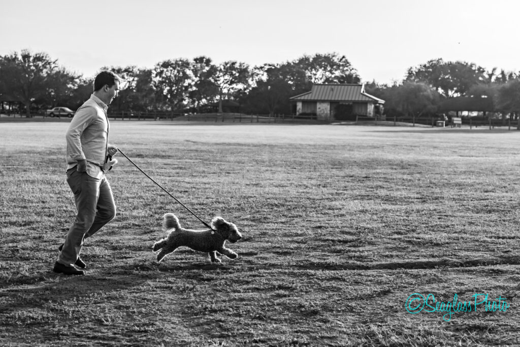 Black and white photo of a guy running with his dog at Riverside Park 