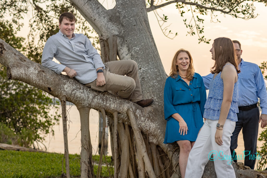 Vero Beach family laughing by a big tree by the river in Vero Beach Fl