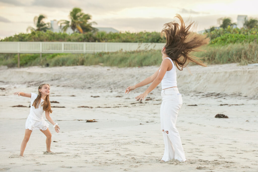 candid of girls jumping and doing cartwheels on the beach