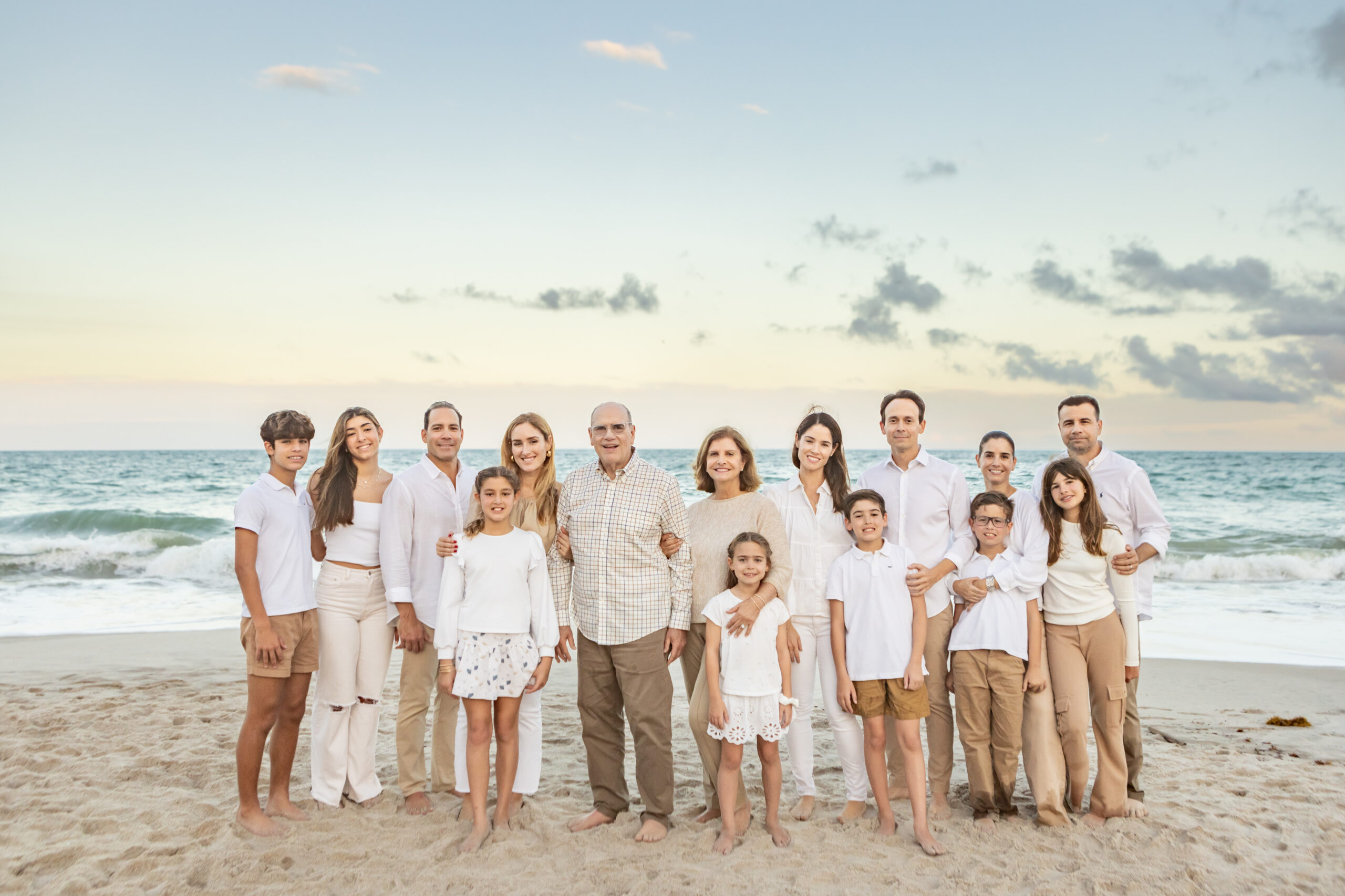 family portrait in Vero Beach with grandparents, kids and grandkids wearing white and khaki at sunset by the ocean