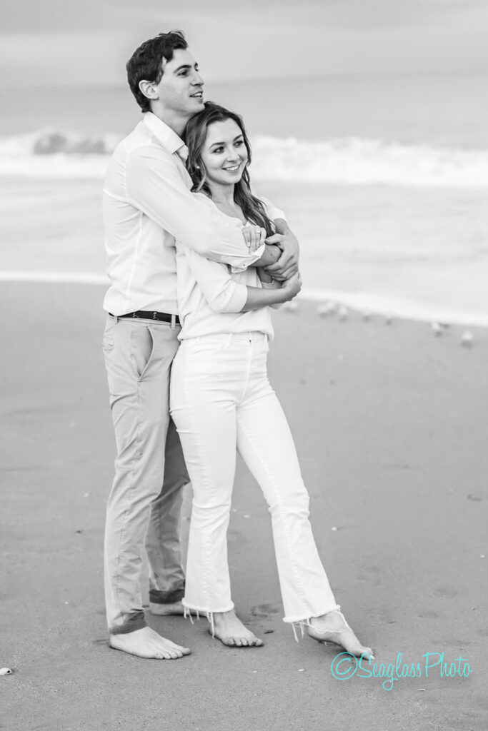 stunning black and white photo of engaged couple holding each other on the beach in Vero Beach Florida 