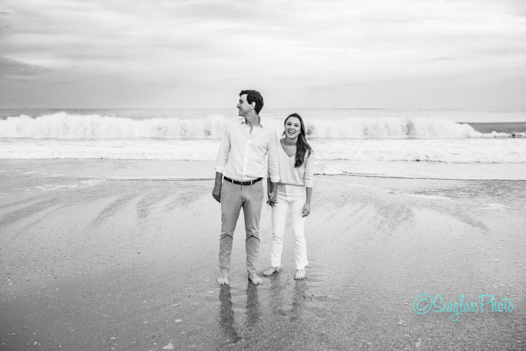 black and white photo of couple laughing on the beach in John's Island