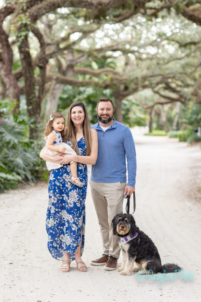 parents playing with their daughter and dog under the oaks on Sandfly Lane Vero Beach Florida