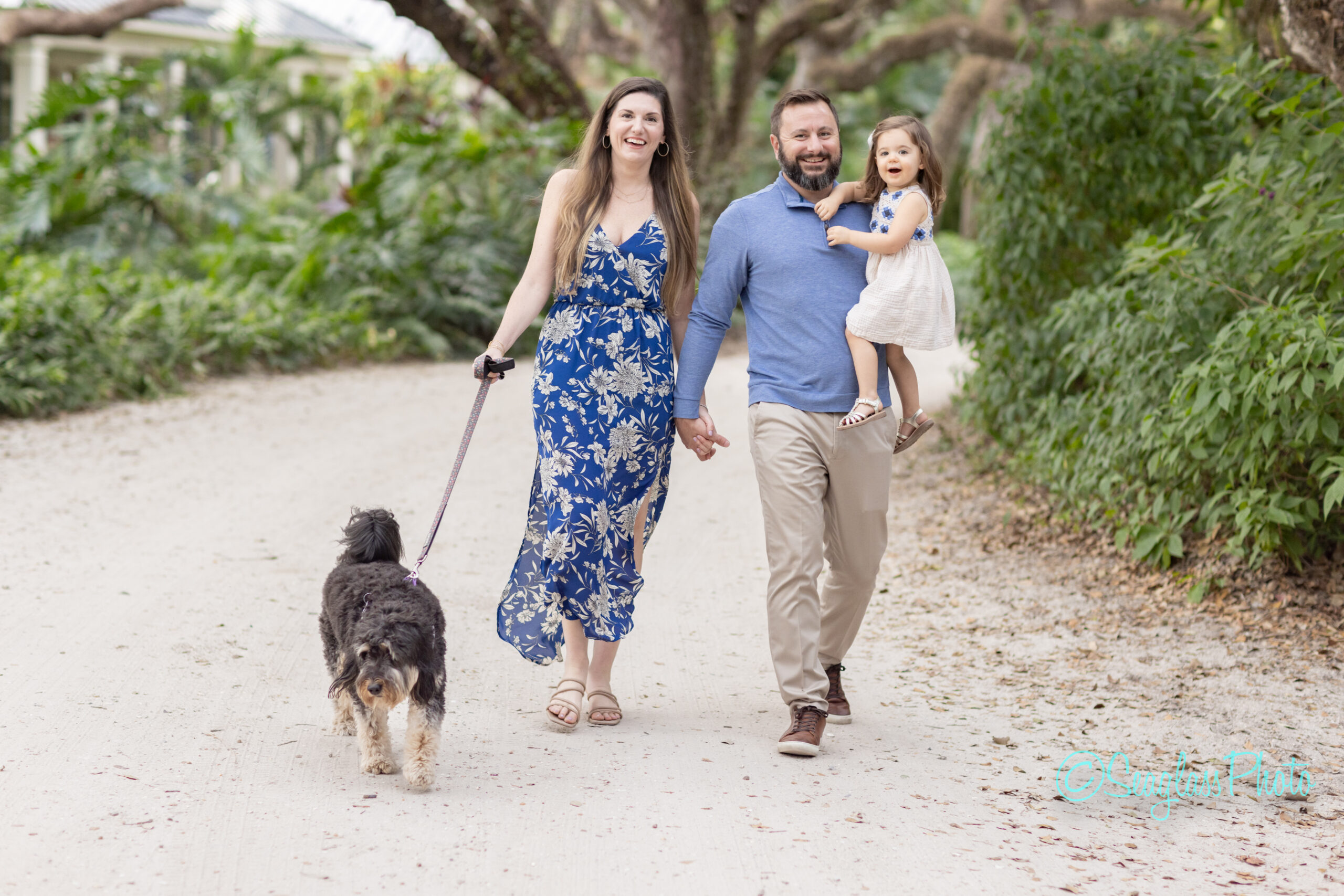 family walking their dog down a dirt road in Vero Beach Florida