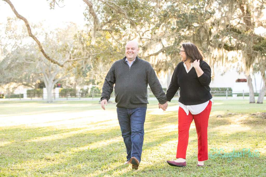 husband and wife walking handing in hand through Riverside Park in Vero Beach Florida 