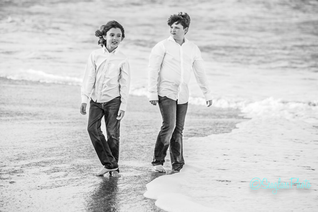 black and white photo of brothers looking at the ocean 