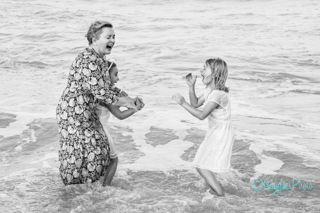 grandma playing in the ocean with her granddaughters in Vero Beach Florida 