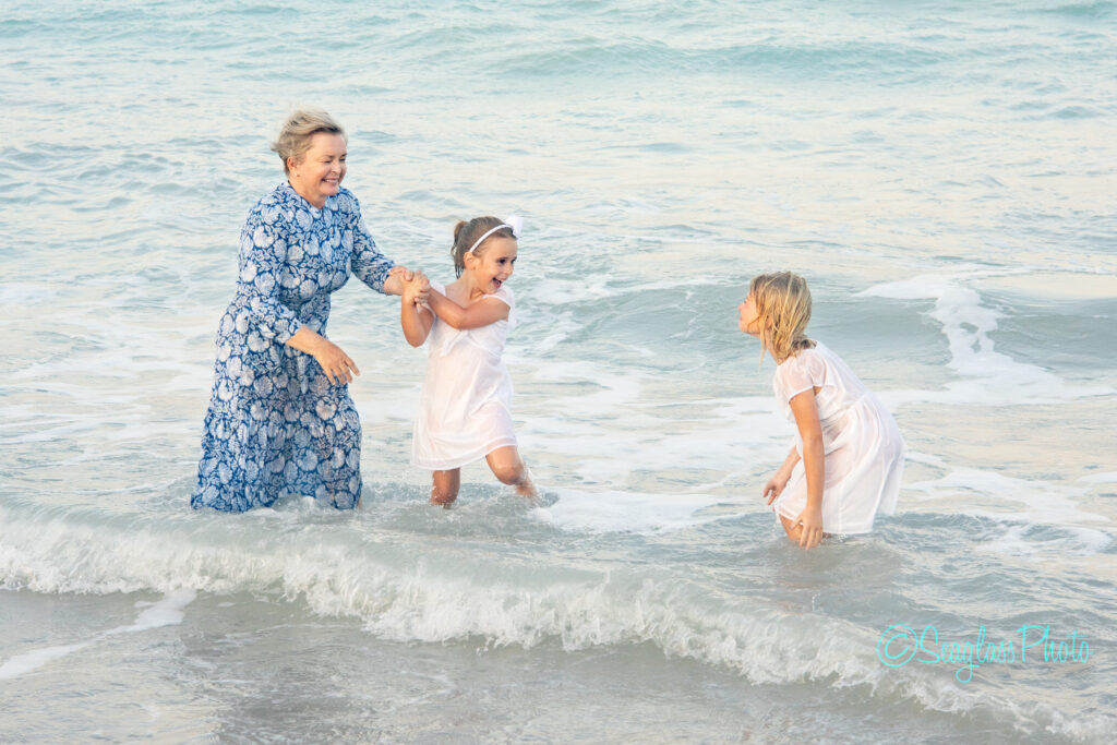 granddaughters playing in the ocean with their grandma in Vero Beach Florida 