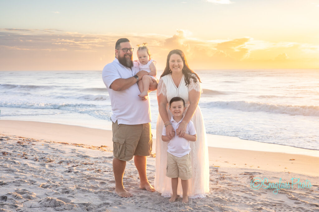 family photo in Vero Beach Florida on the beach at sunrise wearing white and khaki
