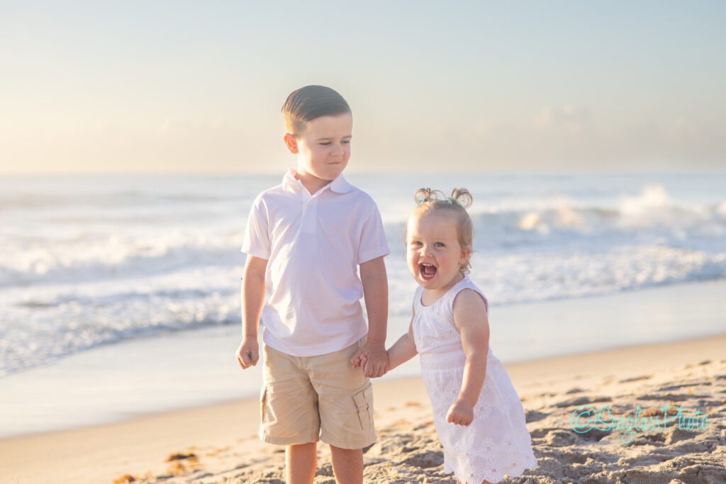 Vero Beach siblings on the beach wearing white for a family photoshoot at sunrise 