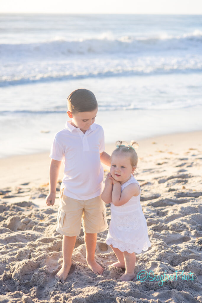 Vero Beach siblings on the beach wearing white for a family photoshoot at sunrise 