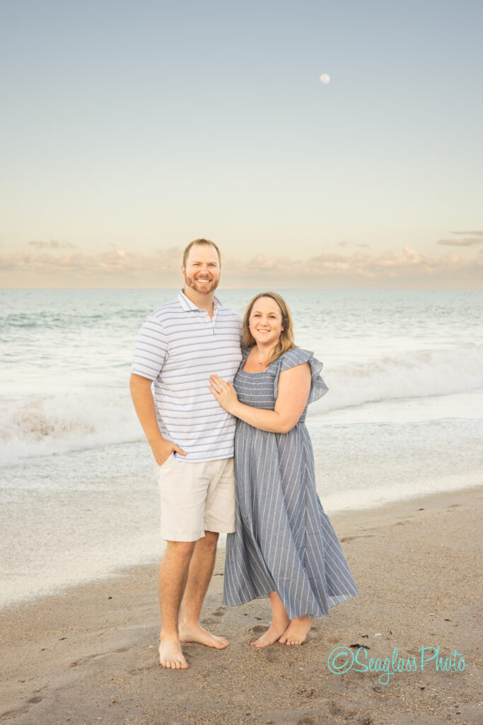 couple standing on the beach at sunset with the moon rising  Disney Vero Beach Resort