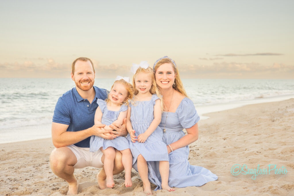 Family portrait with little girls wearing blue and white at the Vero Beach Disney Resort Photoshoot