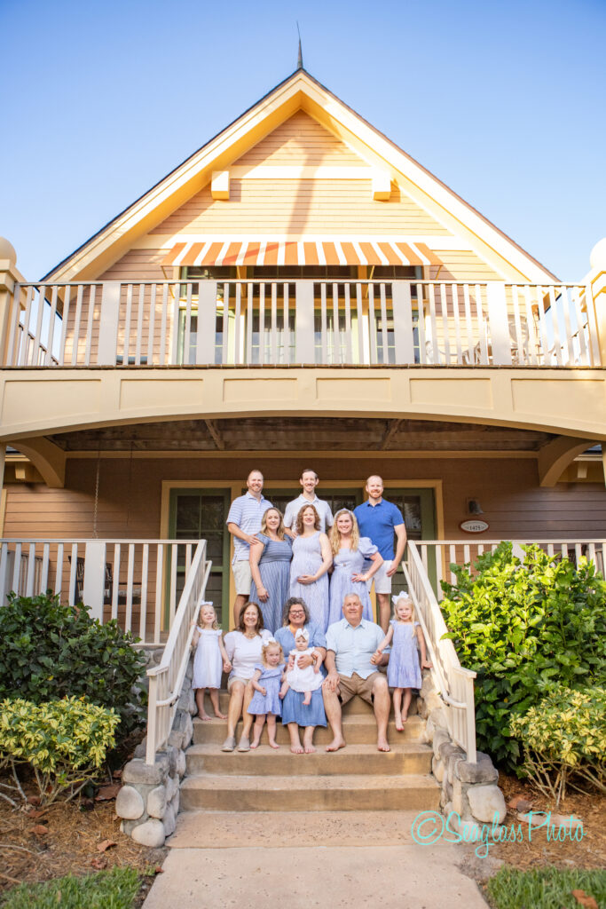 family photoshoot with grandparents and grandchildren sitting on the front porch cottage at Disney Vero Beach Resort