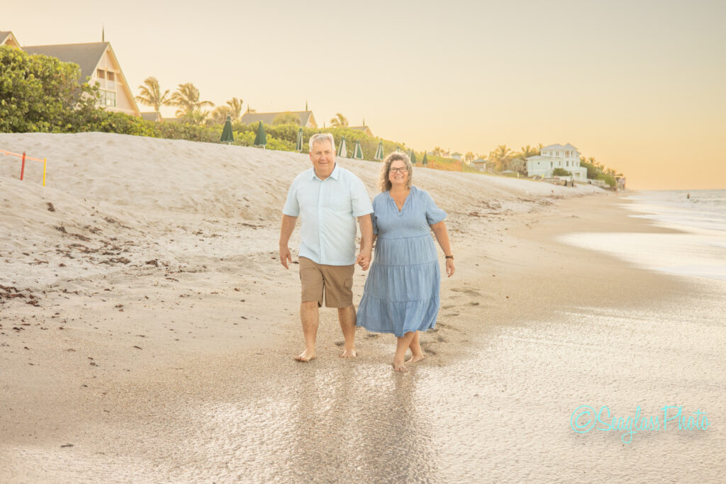 anniversary couple walking down the beach in front of the Disney Vero Beach Resort at sunset