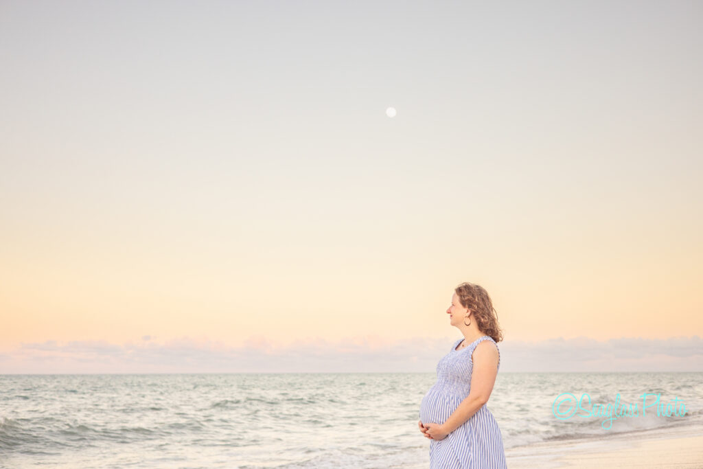 maternity photoshoot  Disney Vero Beach Resort at sunset with a full moon rising over the ocean 