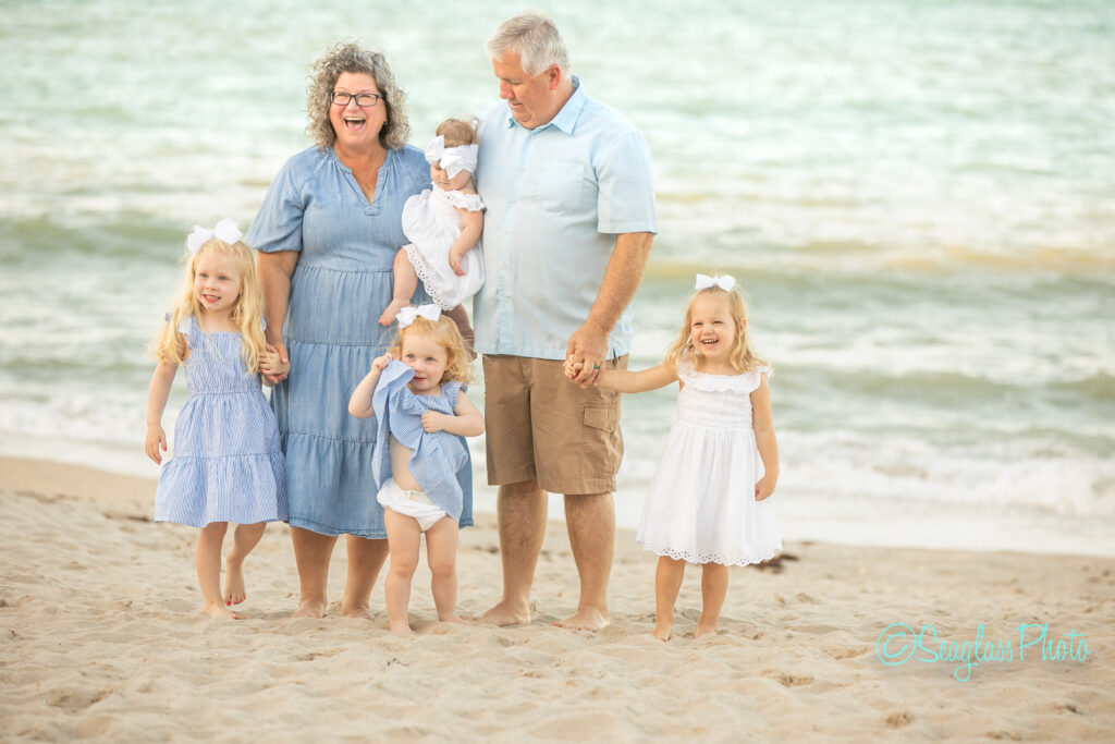 grandparents with the grandkids wearing blue and white in Vero Beach Photoshoot