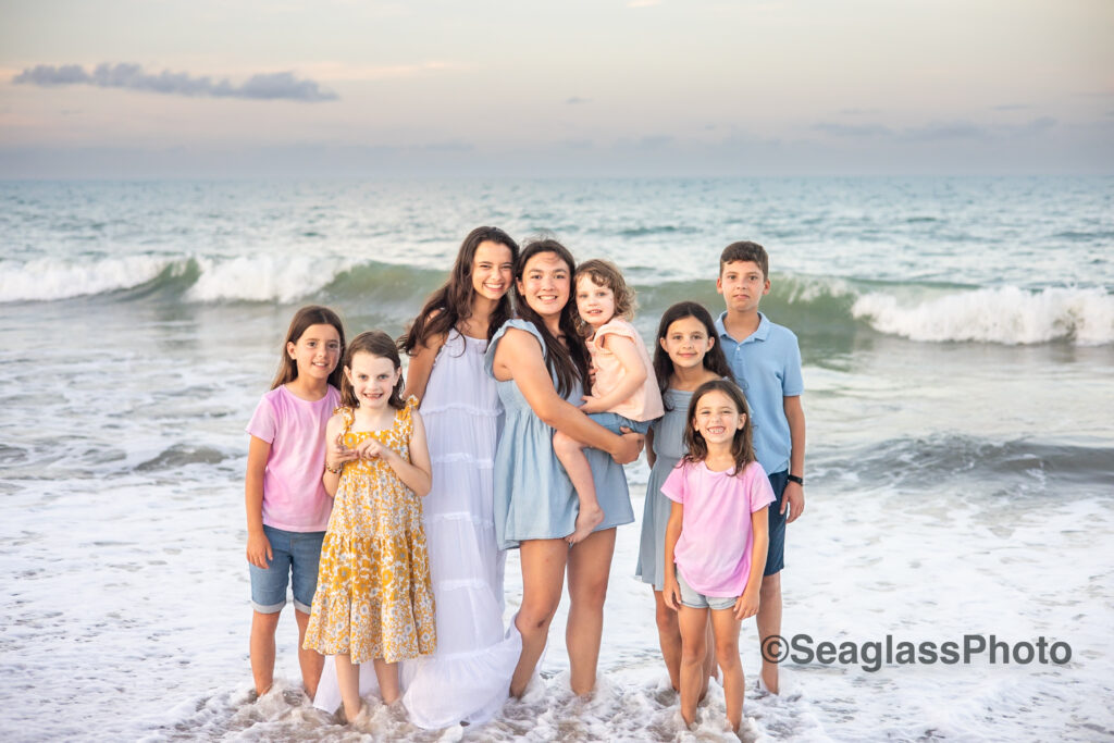 grandkids smiling on the beach wearing colorful clothing