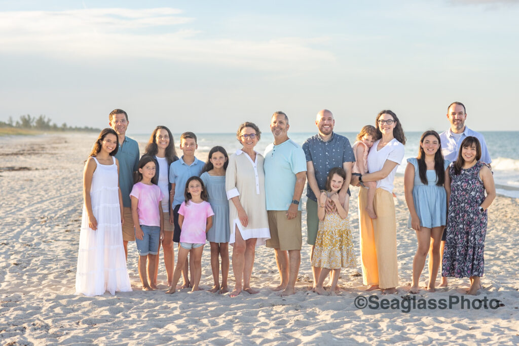 Family photograph on the beach in Ft. Pierce wearing colorful colors 