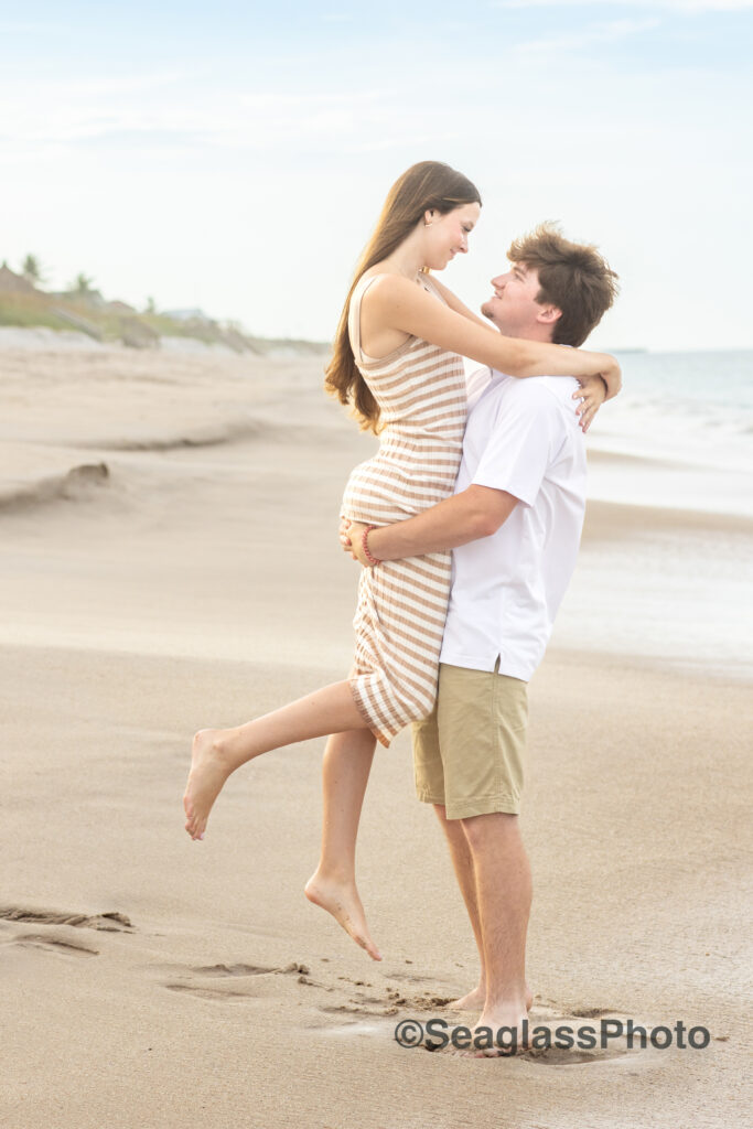 engagement photo in Vero Beach with the man holding up the girl 