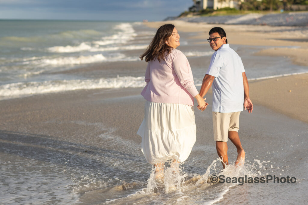 bi-racial couple running on the beach at sunset at the Disney Vero Beach Resort