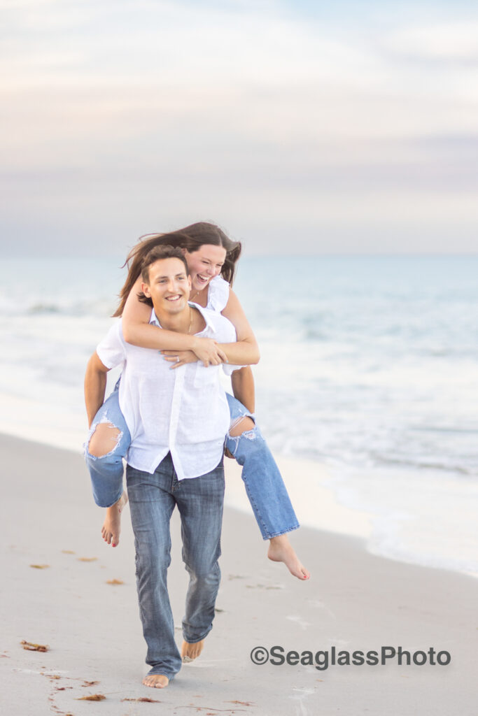 engagement photoshoot of couple in Vero Beach Florida running down the beach at sunset