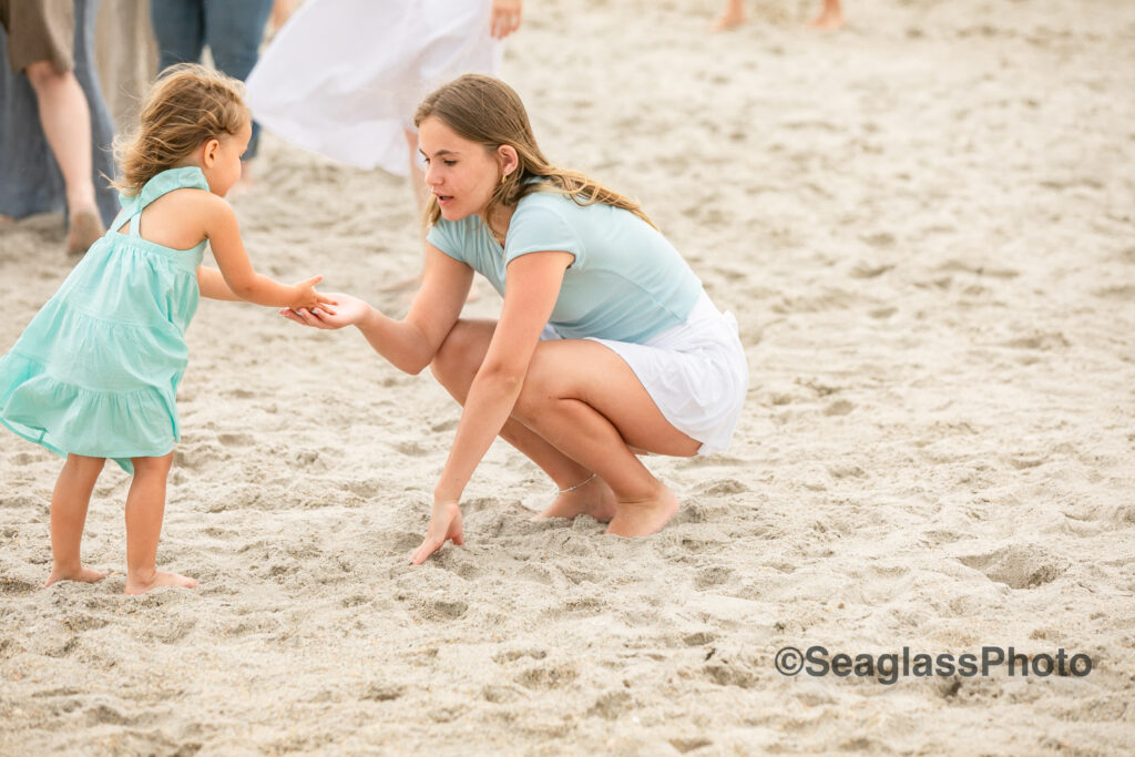 sweet photo of sisters playing in the sand in Vero Beach Florida 