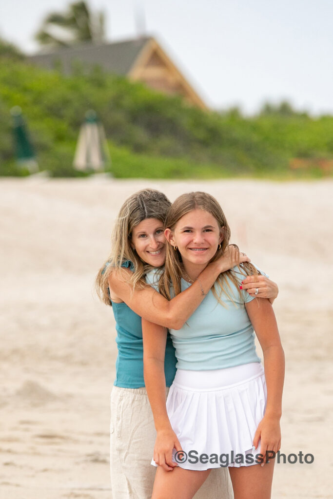 Mother hugging her daughter on the beach in Vero 