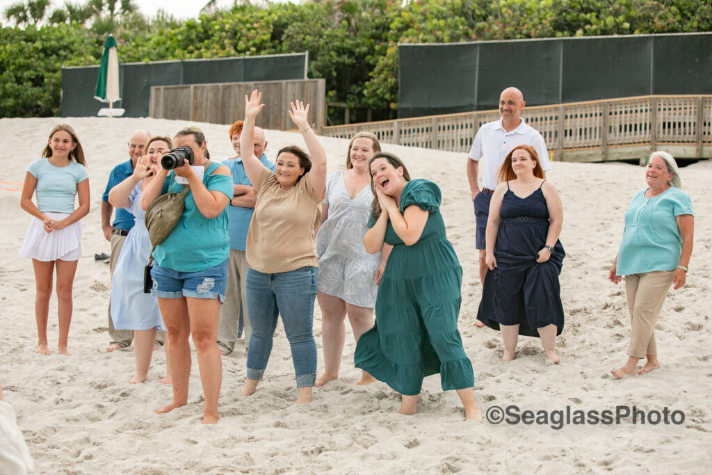 Angela Tappen of Seaglass Photography taking photos on the beach with family acting goofy at the Disney Vero Beach Resort